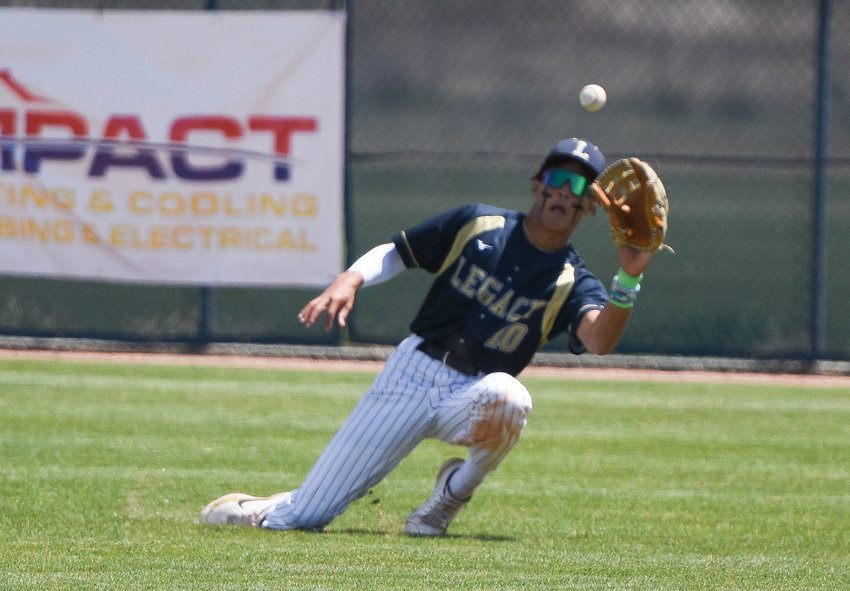 Legacy right fielder Marcus Romero makes a sliding catch of a line drive during a CHSAA 5A regional playoff game against ThunderRidge at Legacy High School in Broomfield May 23. The Lightning shut out the Grizzlies, 8-0.